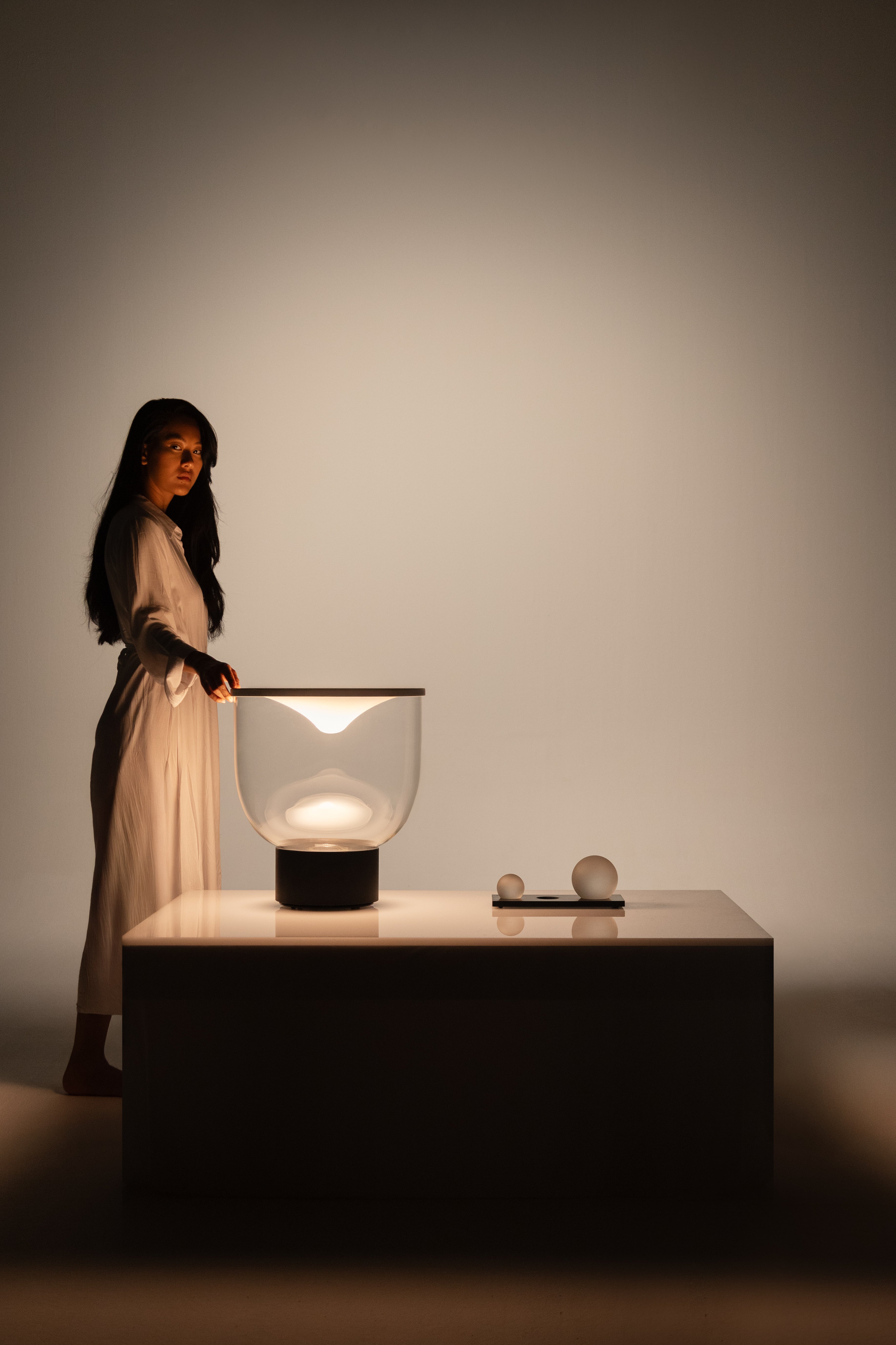 GRAMMOLUCE table lamp with a glass shade and black base.
