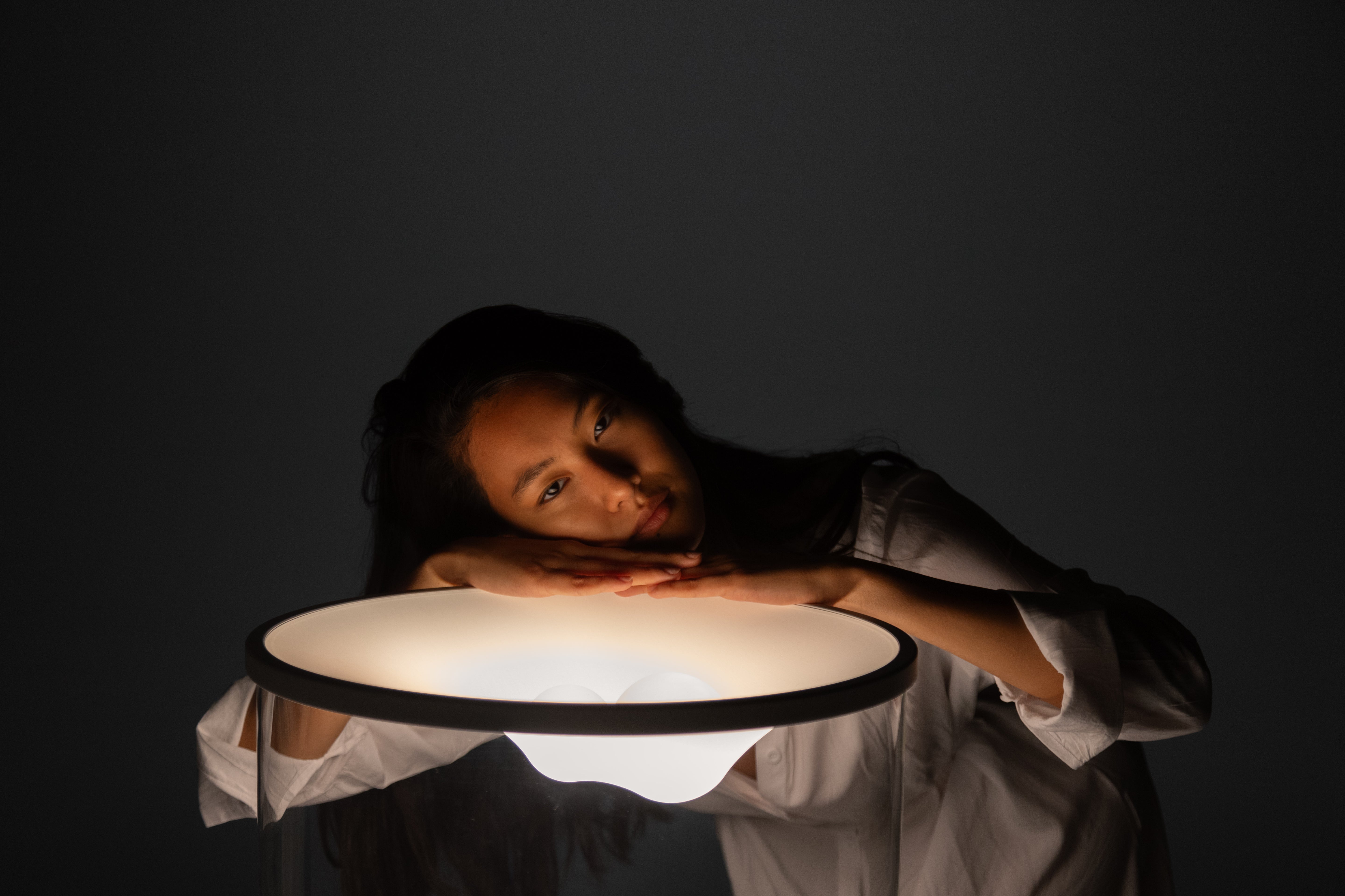 GRAMMOLUCE table lamp with a glass shade and black base.