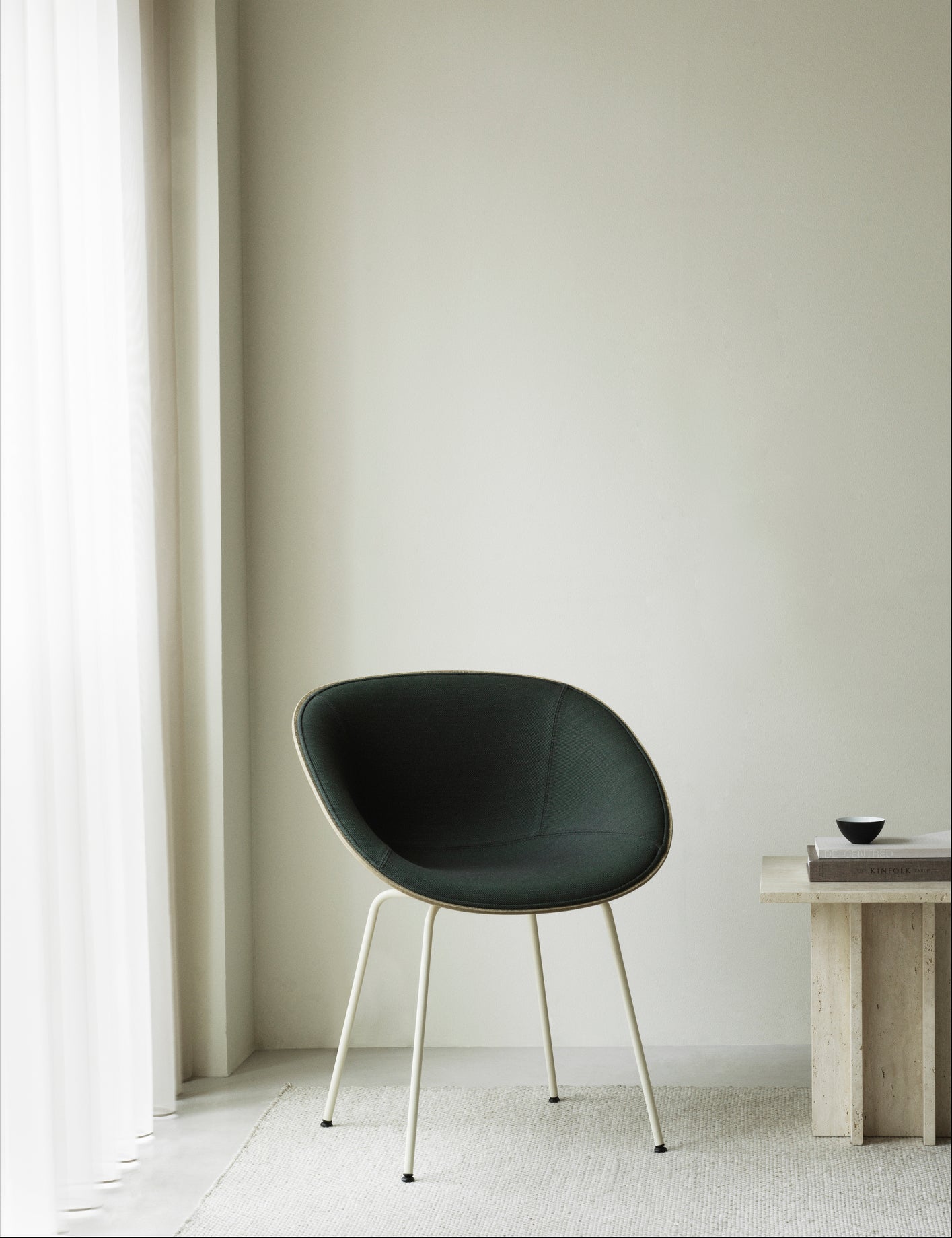 Armchair green upholstered chair with a black base
