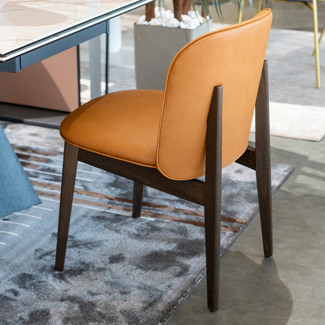 ABREY upholstered chair with a dark wooden base