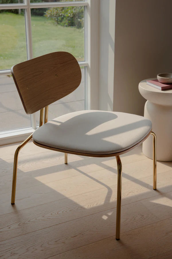 Beige curious armchair with a golden base