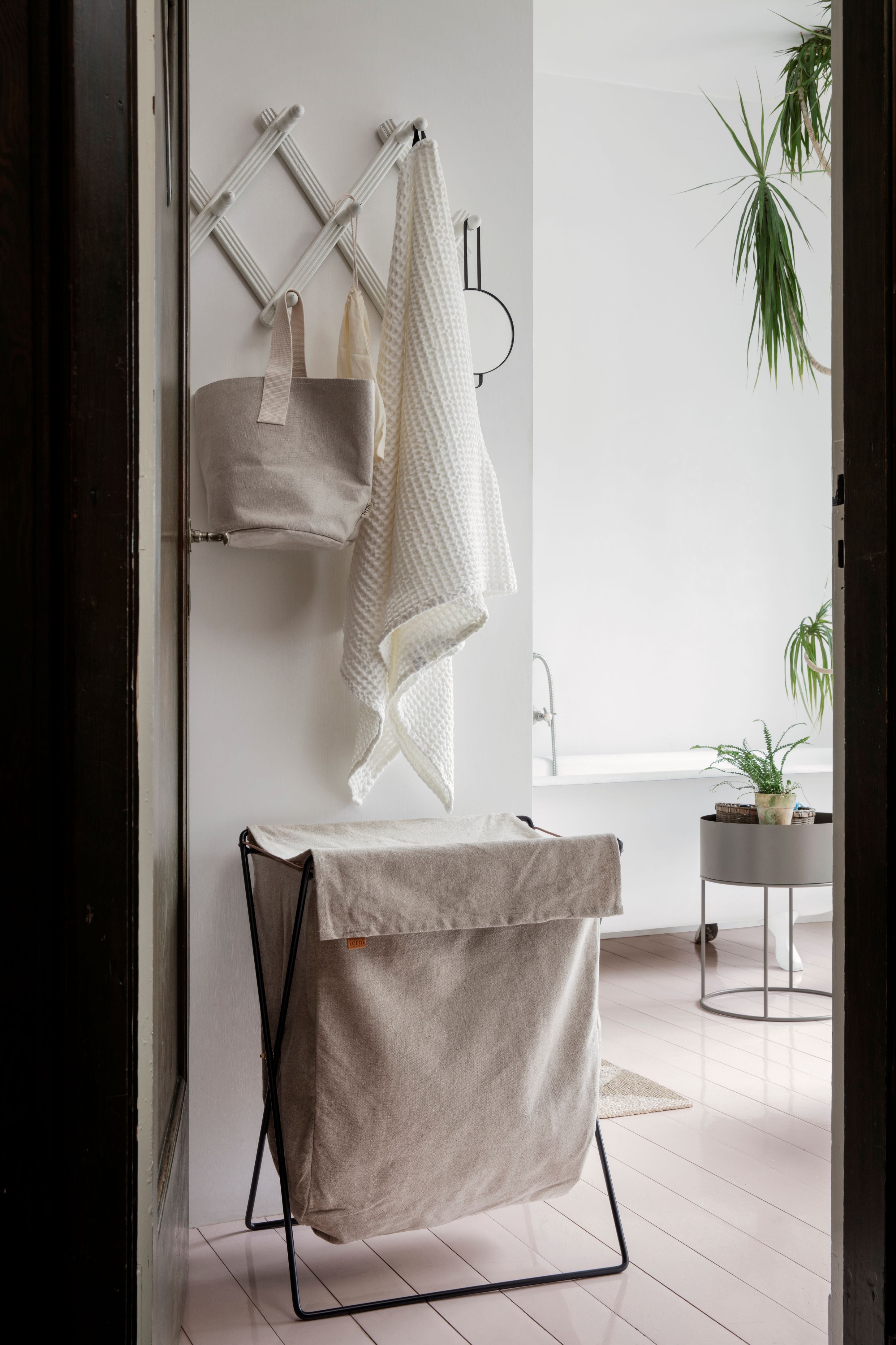 HERMAN beige laundry basket with a black base