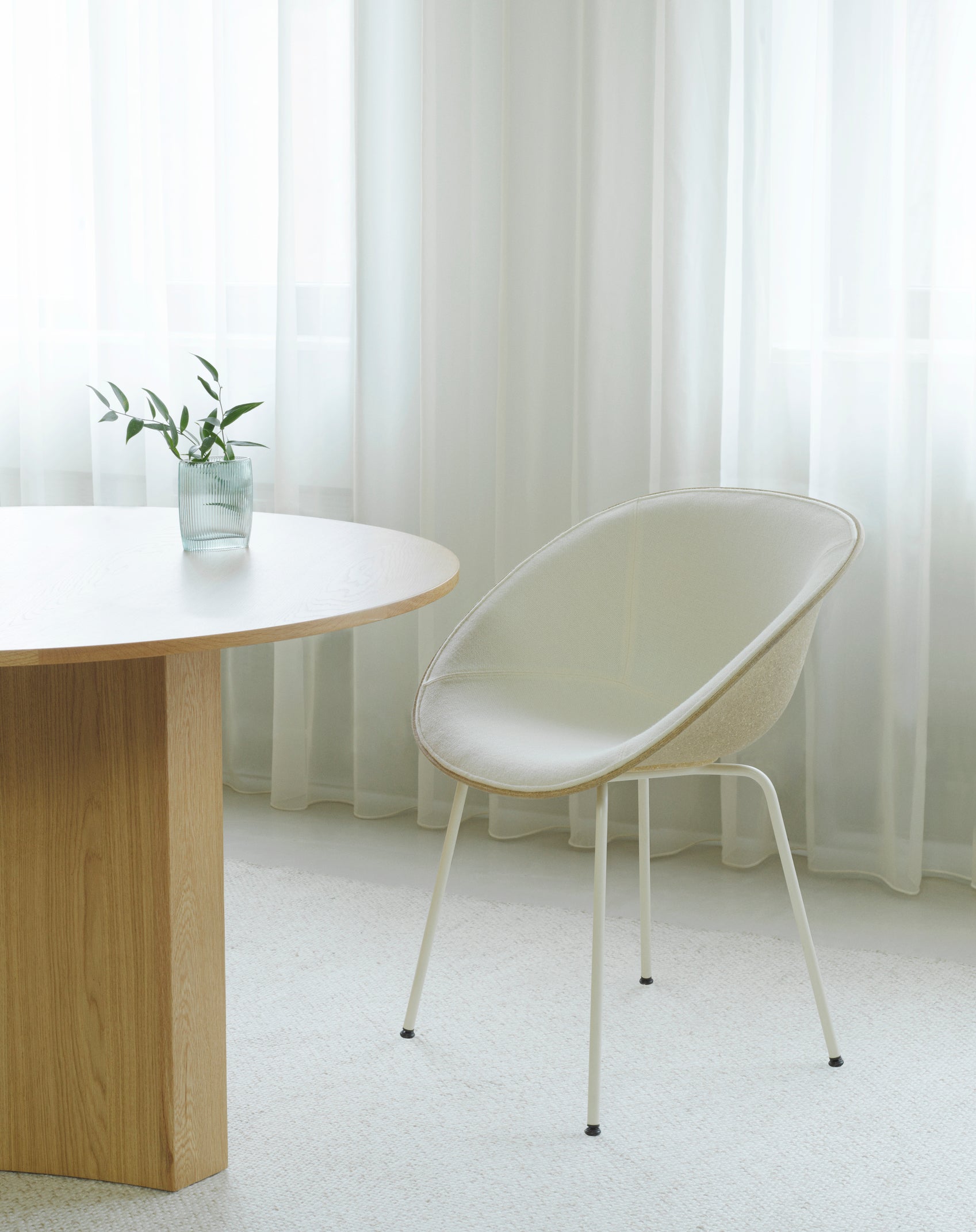 Armchair green upholstered chair with a black base
