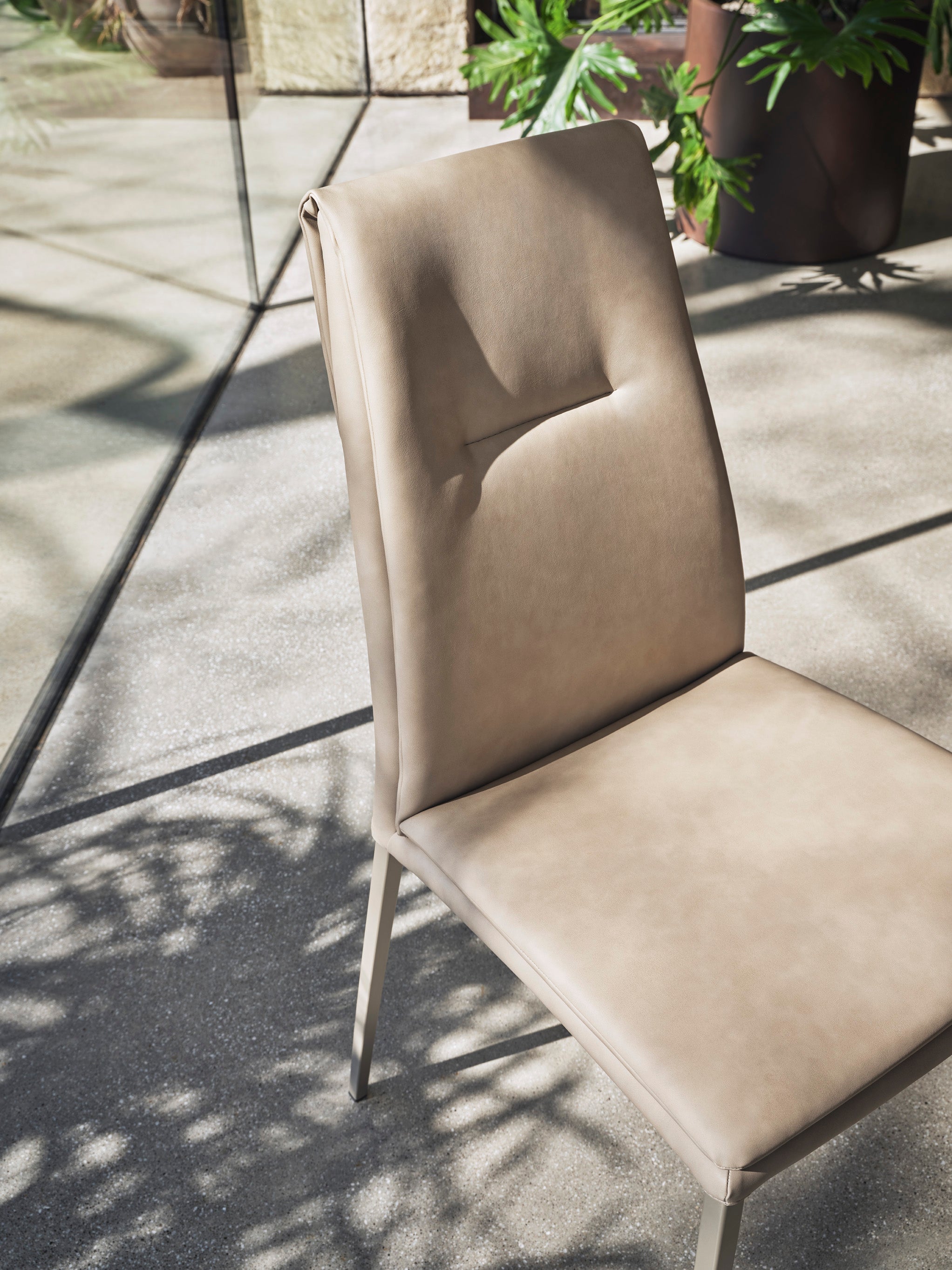 CARMEN upholstered chair with a black base