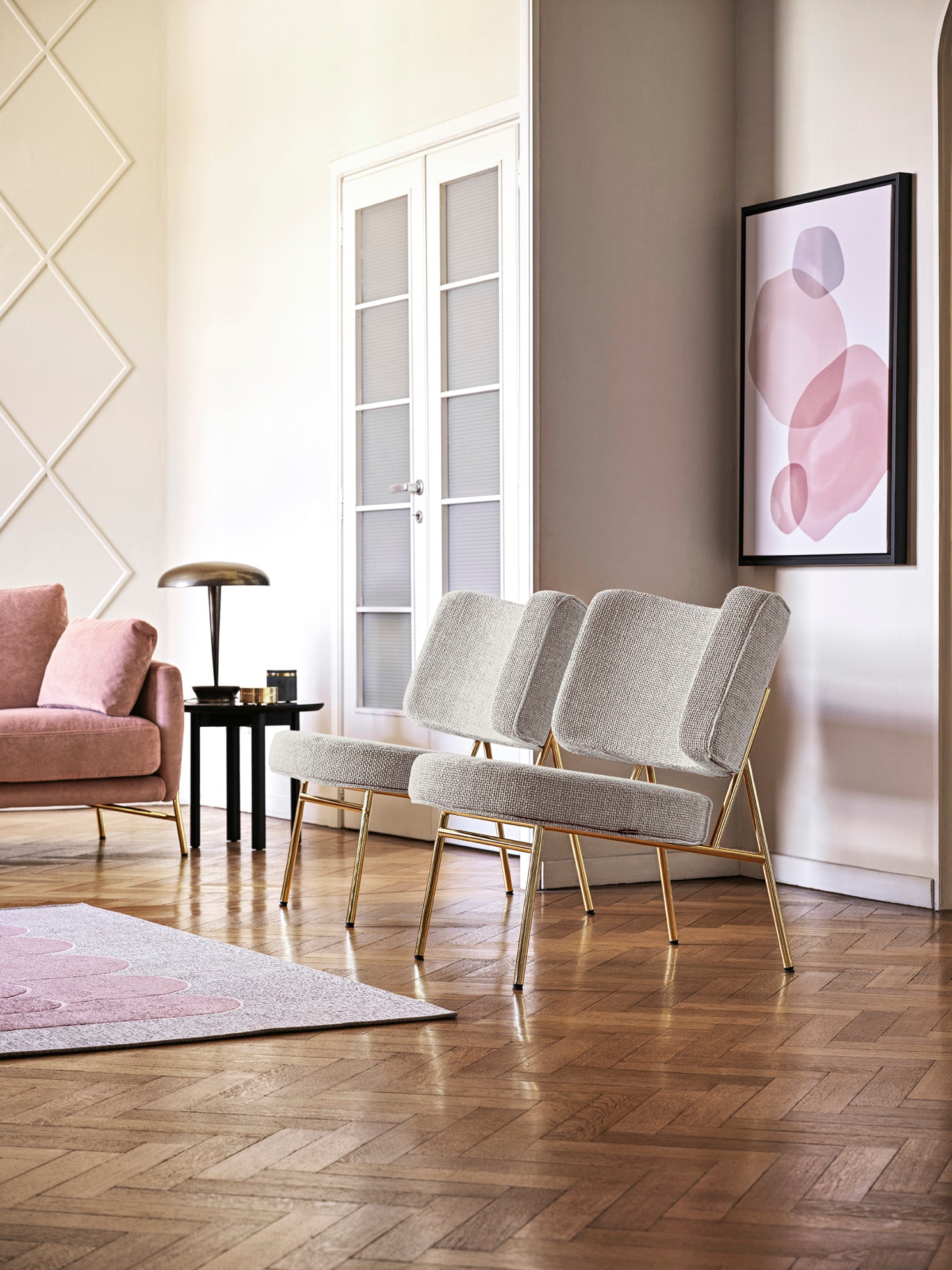 Upholstered COCO armchair with a black base