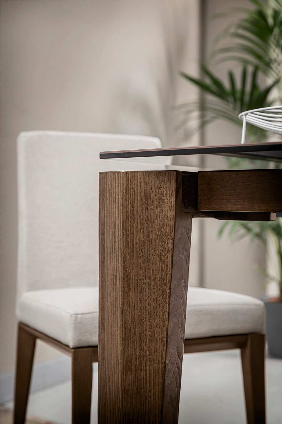 BESS LOW upholstered chair with a dark wooden base