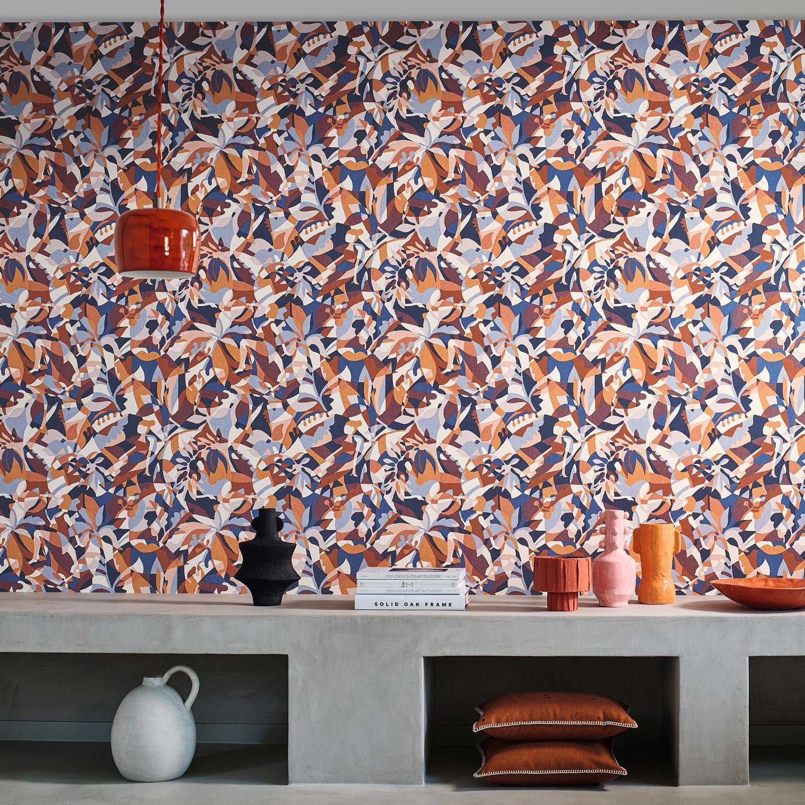 Abstract patterned wallpaper with a botanical motif PLONGEON - MARINE/TERRACOTTA navy blue with terracotta